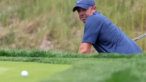 Rory McIlroy at Oakmont looking at his ball