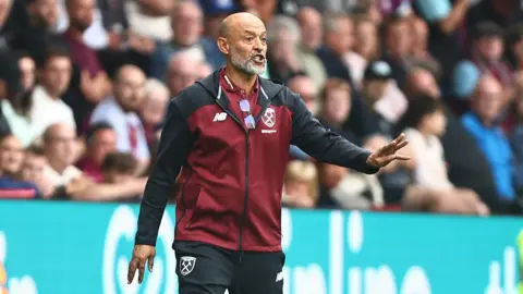Nuno Espirito Santo stands on the touchline with his arm out
