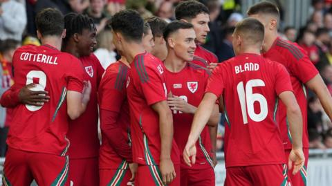 Wales Under-21s celebrate scoring a goal against Denmark