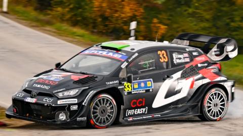 The black Toyota GR Rally1 car of Elfyn Evans negotiates a corner at the Central European Rally