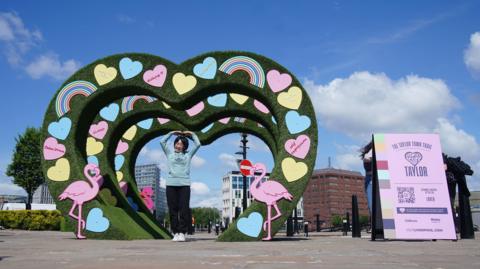 A fan poses at the Lover installation 