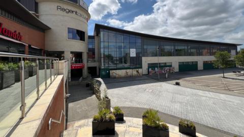 Regent Circus retail and leisure complex in Swindon town centre, with the boarded-up Morrisons store to the right of the image. 