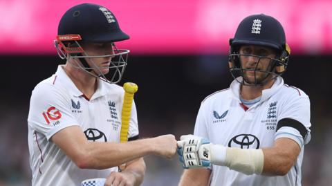 England batter Harry Brook, left, fist-bumps team-mate Joe Root, right