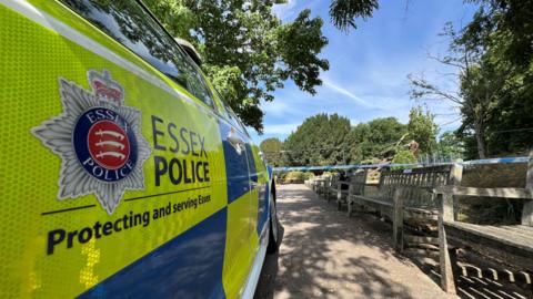 An Essex Police car parked near a cordon. The side of the car reads Essex Police 