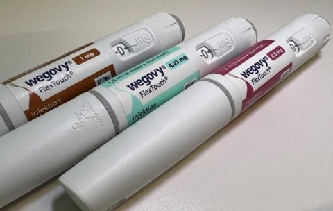 Three Wegovy pens lined up side by side