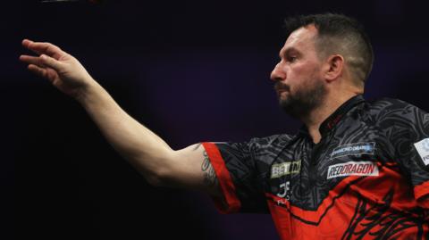 Jonny Clayton throws a dart