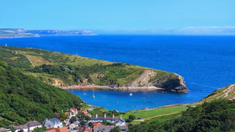 Blue sky over Lulworth Cove in Dorset