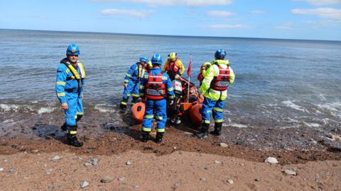 The Whitby inshore lifeboat on the beach at Saltwick Bay, near Whitby.