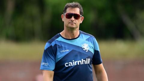 Jason Kerr wearing sunglasses and standing at the County Ground during a match this season