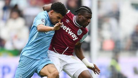 Morgan Gibbs-White and Mohammed Kudus battle for possession in a game between Nottingham Forest and West Ham
