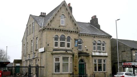A three-storey Victorian pub building. It looks dishevelled and empty from the outside.