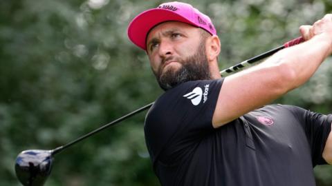 Jon Rahm hitting a golf shot