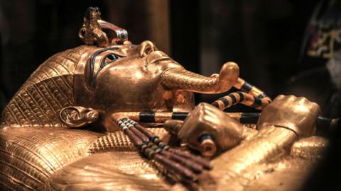 The golden funerary mask of ancient Egyptian pharaoh Tutankhamun is displayed at the Grand Egyptian Museum near the Giza Pyramids in Giza, Egypt, on November 4, 2025. The museum hosts hundreds of artifacts reflecting thousands of years of Egyptian history. Tutankhamun, who ruled during the 18th dynasty of the New Kingdom (13321323 BC), ascended to the throne at age nine and died suddenly at nineteen, sparking ongoing research into the cause of his death.