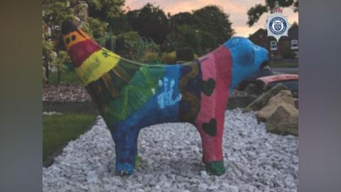 A side view of the multicoloured painted Superlambanana sculpture