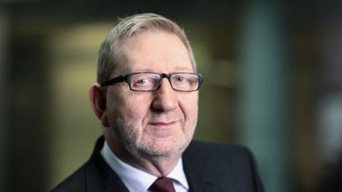 Headshot portrait of Len McCluskey