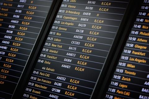 Departure board at Heathrow airport showing flights to New York, LA and others