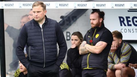 Burton Albion interim manager Tom Hounsell (left) looks on from the dugout during a match