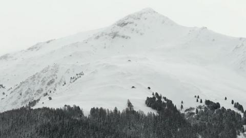 Image shows a snow-covered mountain in the French Alps