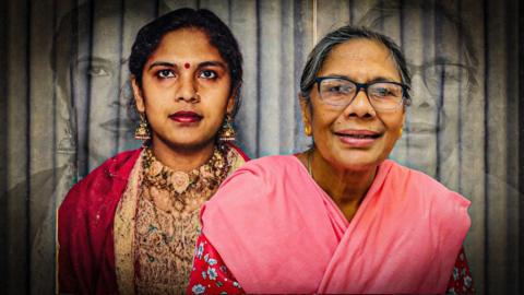 A younger version of the same woman stands beside her older self.
The younger self wears a red and gold embroidered outfit with jewellery, while the older self wears glasses and a pink patterned top, with faint larger copies of both images behind them.