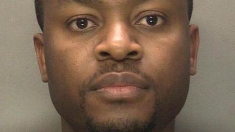 A police mugshot of a man looking into the camera.