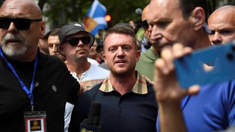 Stephen Yaxley-Lennon aka Tommy Robinson surrounded by his security staff at a July 2024 London demonstration