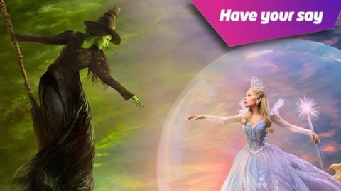 Ariana Grande as Glinda the Good Witch and Cynthia Erivo as Elphaba. With a sign top right that reads: Have Your Say. 