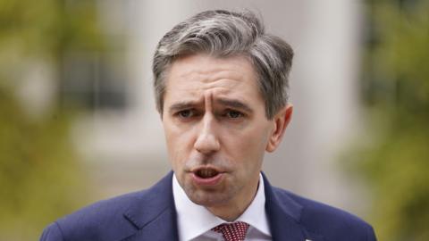 A close up of Taoiseach Simon Harris wearing a suit 