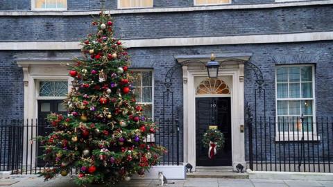 Decorated Christmas tree to the left of Number 10 Downing Street in 2024