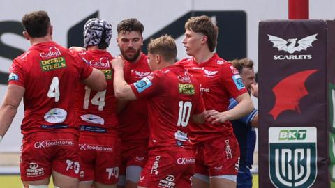 Scarlets players celebrate scoring a try against Leinster in Llanelli
