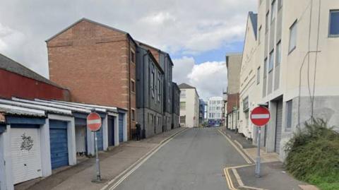 A stock image of King Street, a one-way road with buildings on either side