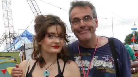 A young woman with a man at a music festival