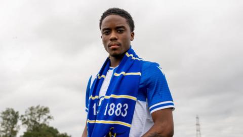 Micah Antony wearing a Bristol Rovers scarf