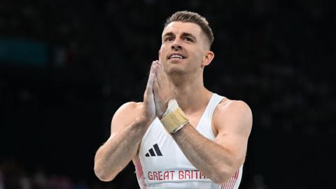 Max Whitlock puts his hands together after a routine