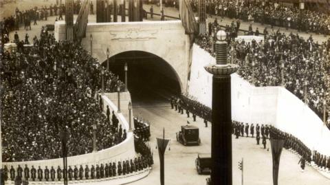 Crowds line the streets around the Queensway Tunnel entrance in 1934