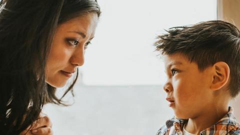 A mother and her son looking into each other's eyes