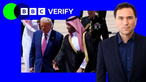Donald Trump speaks to Crown Prince Mohammad bin-Salman in Saudi Arabia. Trump is wearing a blue suit and a Marine in full uniform trails the pair. The BBC verify colours and Ros Atkins have been imposed over the image.  