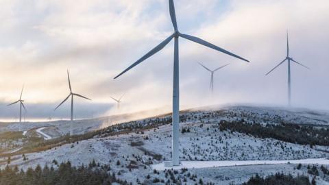 A wind farm seen in the UK in a snowy hilly region in South Lanarkshire.