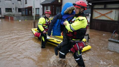 A child is rescued during Storm Babet flooding last year