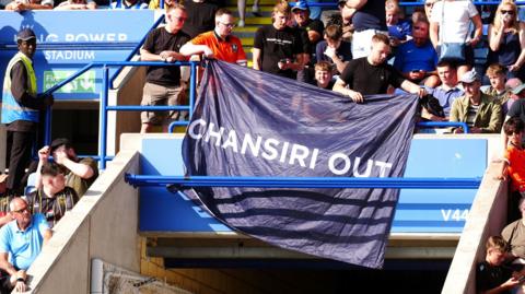 Sheffield Wednesday fans display a 'Chansiri Out' banner at Leicester
