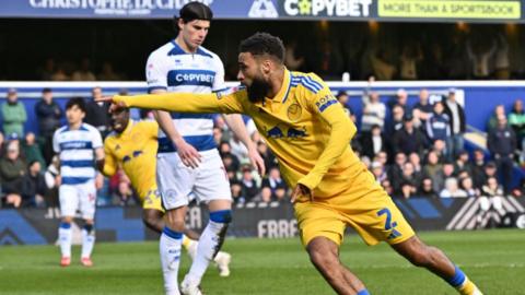 Jayden Bogle celebrates after drawing Leeds level at QPR