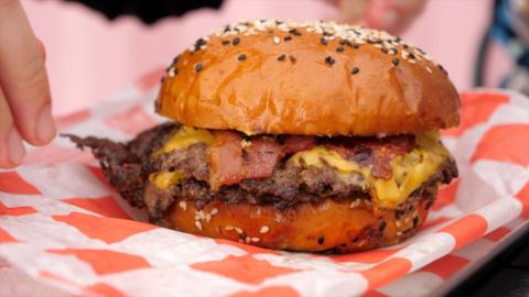 A bacon and cheese burger in a bun