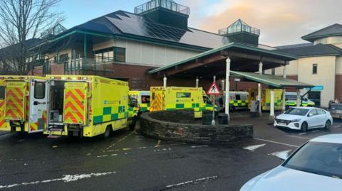 Seven ambulances outside a hospital emergency department