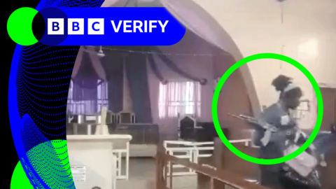 A man with an assault rifle grabbing handbags off pews inside a church