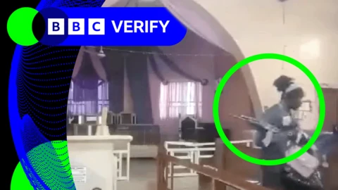 A man with an assault rifle grabbing handbags off pews inside a church