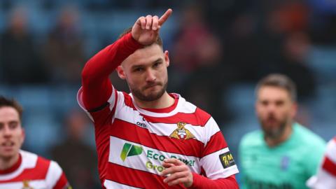 Doncaster's Luke Molyneux celebrates scoring at Gillingham