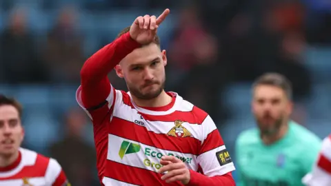 Doncaster's Luke Molyneux celebrates scoring at Gillingham