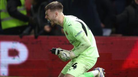 Josh Keeley celebrates after saving a penalty for Leyton Orient