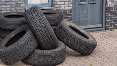 A pile of tyres on the ground.