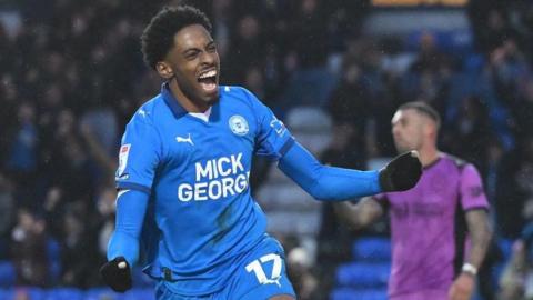 Kyrell Lisbie - with fists clenched - celebrates his hat-trick against Wigan 