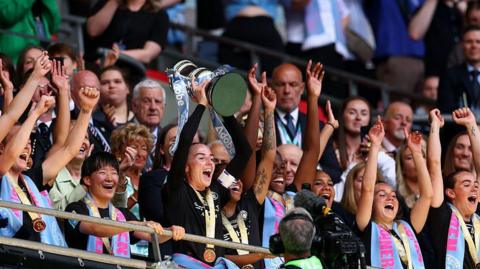 Alex Greenwood lifting the trophy.